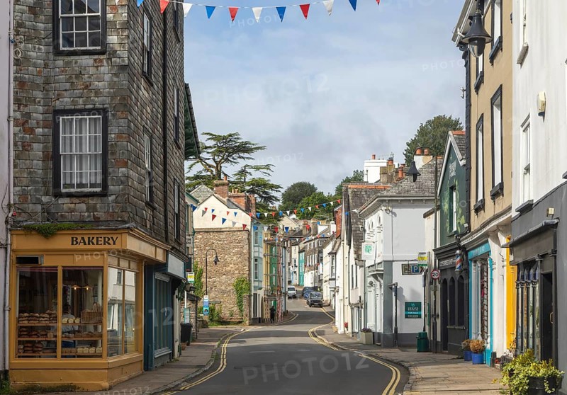 Shops in historic buildings in West Street, town of Ashburton, Devon, England, UK
