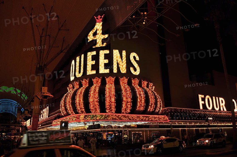 Glowing 4 Queens casino sign at night with majestic-looking crown, Las Vegas, Nevada, USA