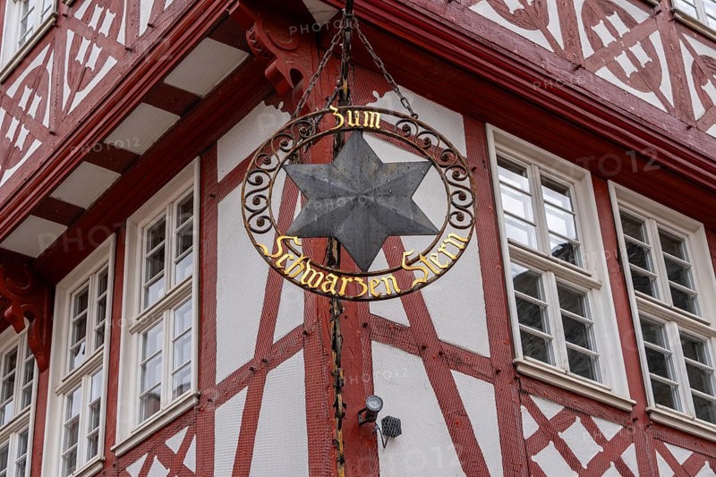 Guild signs and half-timbered houses on the Römerberg in Frankfurt am Main, Hesse, Germany