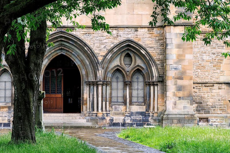 Gothic revival arched stone doorway of Govan Old Parish Church, home to the early medieval Govan Stones collection, Govan, Glasgow, Scotland, United Kingdom