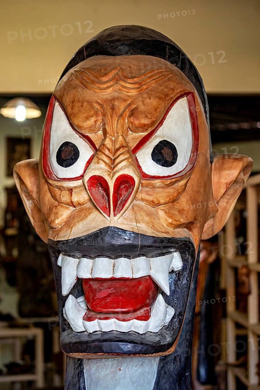 Expressive, colorful mask sculpture with big eyes and open mouth, artisan leg carving masks in Petrolina Brazil