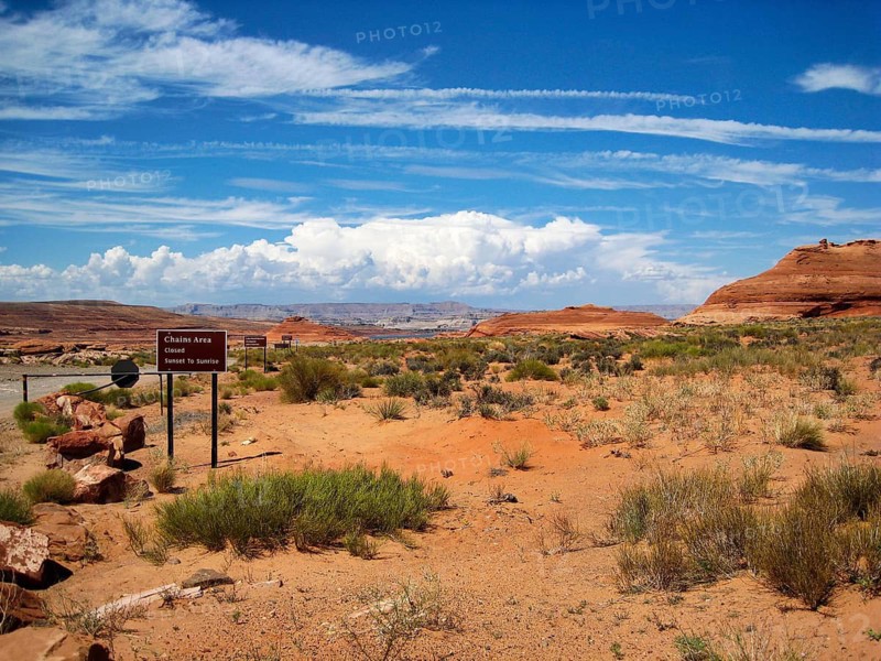 Barren desert landscape and typical red sandstone formations, Lake Powell on the horizon, hiking in the Chains Area, Page, Arizona, USA