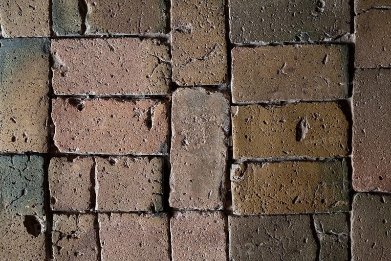 Detailed view, floor with old earth-colored bricks crisscrossed by cracks, church, Husby Church, Husby, Holstebro Municipality, Denmark