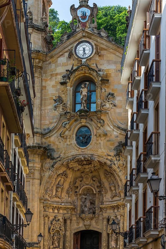 The shopping street Calle Mayor with the Basilica of Santa María del Coro in San Sebastian, Basque Country, Spain