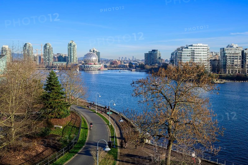 The Seawall along False Creek with Science World and residential buildings on a winter day, Vancouver, British Columbia, Canada