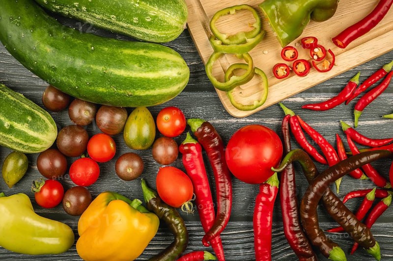 Various vegetables, cucumbers, tomatoes, sliced peppers and chili peppers