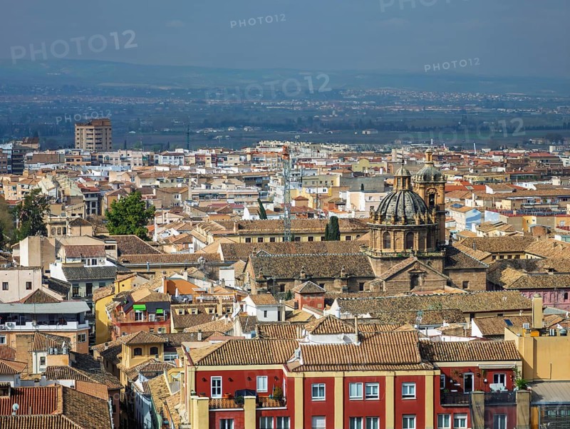 Aerial view of Church of Saints Justo and Pastor baroque church in Granada, Spain, showing granada cityscape, saint jerome monastery, church dome, historical center, and city skyline