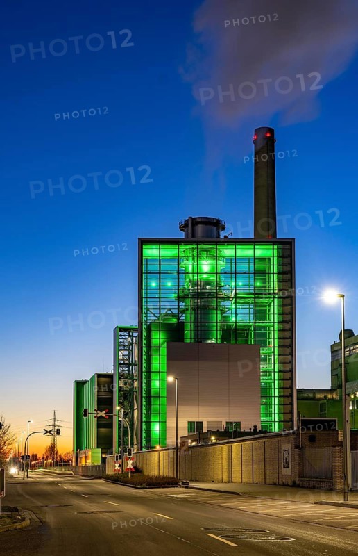 The Lausward combined heat and power plant in Düsseldorf, gas and steam turbine power plant, operated by Stadtwerke Düsseldorf and EnBW, in the harbour of Düsseldorf on the Rhine, green illuminated city window, the chimney of the Fortuna power plant unit, the power plant generates electricity, also traction current and district heating, North Rhine-Westphalia, Germany