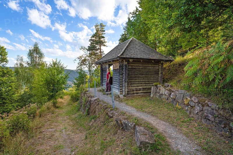 Small hut on hiking trail with green forest and blue sky, Bad Wildbad, Black Forest, Germany