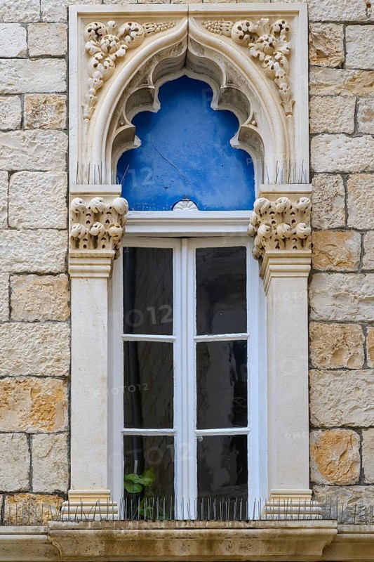 An arched window above a door in the Cipiko Place, Trogir. The Venetian Gothic style was prevalent in the 15th century