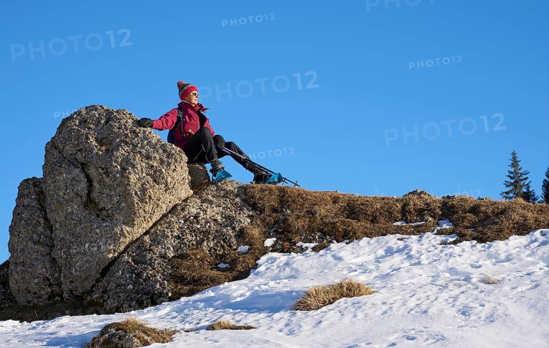Nice and active senior woman snowshoeing in in the Allgau alps above Immenstadt, Bavaria, Germany