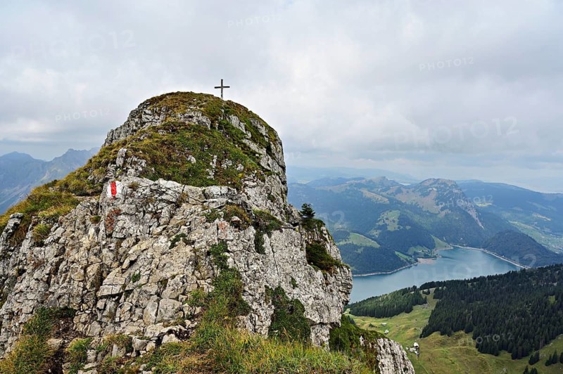 Summit of Zindlenspitz with cross, Wägitalersee and Kleine und große Aubrig in the back, Innerthal, Canton of Schwyz, Switzerland
