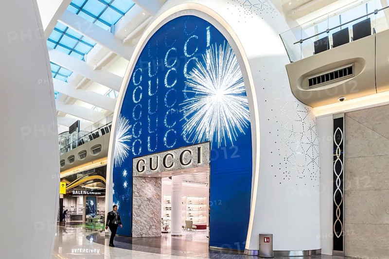 Abu Dhabi Airport, Zayed International Airport with passengers. Duty free shop of the Gucci brand. The new Terminal A has a capacity of 45 million passengers per year. Modern architecture. Abu Dhabi, United Arab Emirates, UAE
