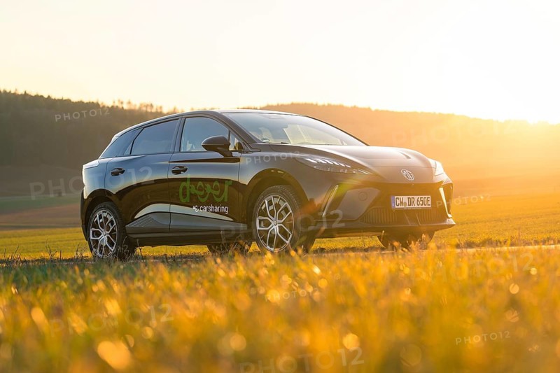 Black SUV parked in a field at sunset, surrounded by countryside, e-car sharing vehicle from Deer Mobility, Gechingen, Black Forest, Germany