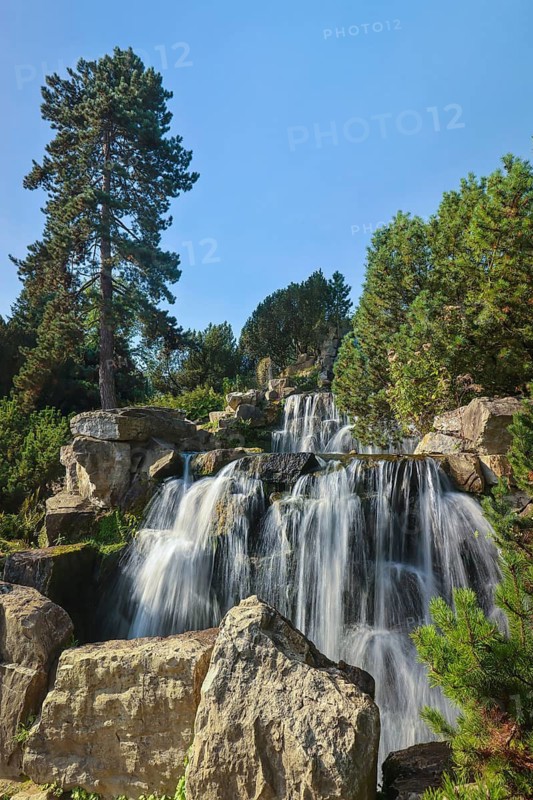 Essen, North Rhine-Westphalia, Germany - Alpinum with waterfall, Grugapark, a park in Essen, emerged from the first Great Ruhrland Horticultural Exhibition in 1929, was the park grounds of the 1965 Federal Garden Show
