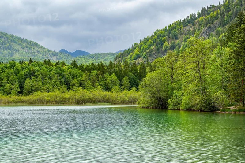 Landscape of Lake Offensee after rain when the sun comes through the clouds in spring, Salzkammergut, Austria