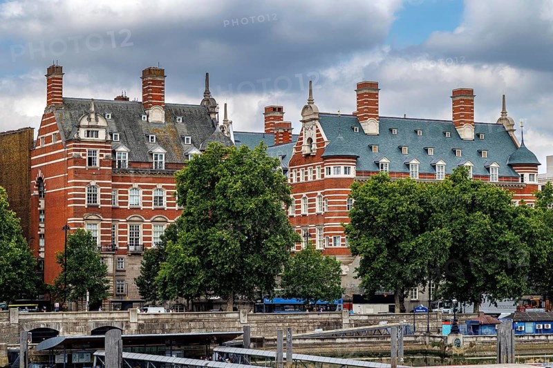 Ornate red brick chimneys and steep gables rise above the former New Scotland Yard building, designed by Richard Norman Shaw and built between 1887 and 1906. It served as Metropolitan Police headquarters until 1967 and is now known as Norman Shaw North and South, London, England, United Kingdom