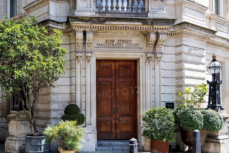 The grand stone facade of the former Bow Street Magistrates' Court reflects a judicial history dating to 1740 when Sir Thomas de Veil sat as magistrate. The 1881 courthouse became famous for landmark criminal and extradition cases. London, England, United Kingdom