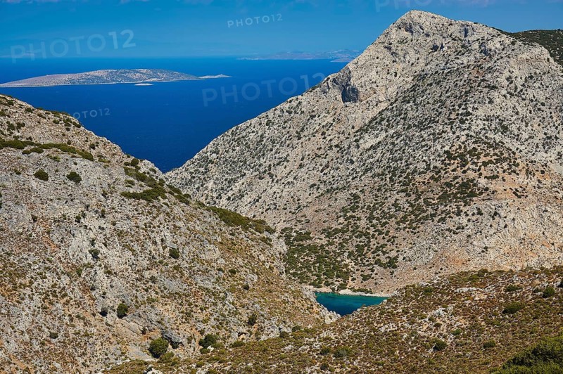 Pezonda Bay, mountainous landscape overlooking the sea under a bright blue sky, Kalymnos, Sponge Diving Island, Dodecanese, Greek Islands, Greece