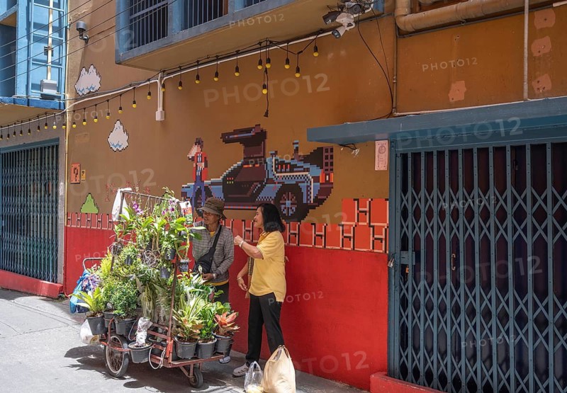 Bangkok, Thailand. August 18th 2026. A local man selling flowers and plants from a mobile cart in the colourful streets of Chinatown District of Bangkok, Thailand, Asia