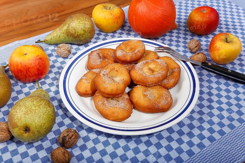Swabian cuisine, harvest cakes, dessert, dessert, fat baked goods, doughnuts, fried food, lard noodles, arranged on a plate, grandmother's kitchen, regional, home cooking, typical Swabian, classic recipe, traditional cuisine, food photography, autumn atmosphere, apples, pears, nuts, still life, studio, Germany