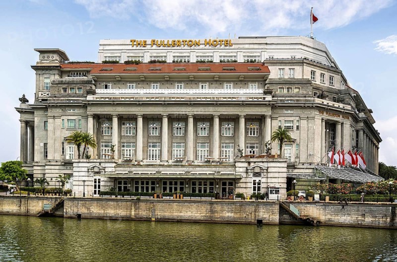 Grand neoclassical colonnade of the former General Post Office now houses the luxury riverside Fullerton Hotel facade beside the Singapore River, Singapore