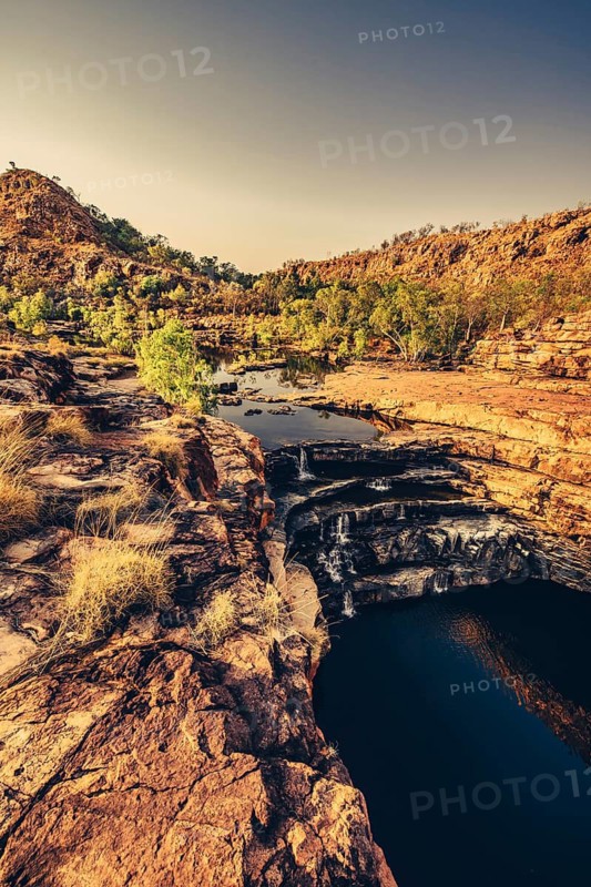 Bell Gorge waterfall, a body of water in north-west Australia in the Kimberley. Sunrise in the outback, Australia