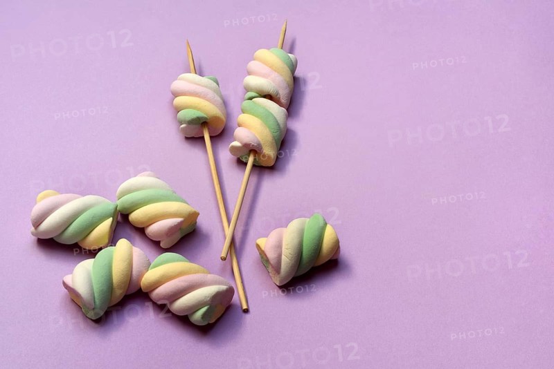 Marshmallows on skewers, pastel-coloured foam sugar