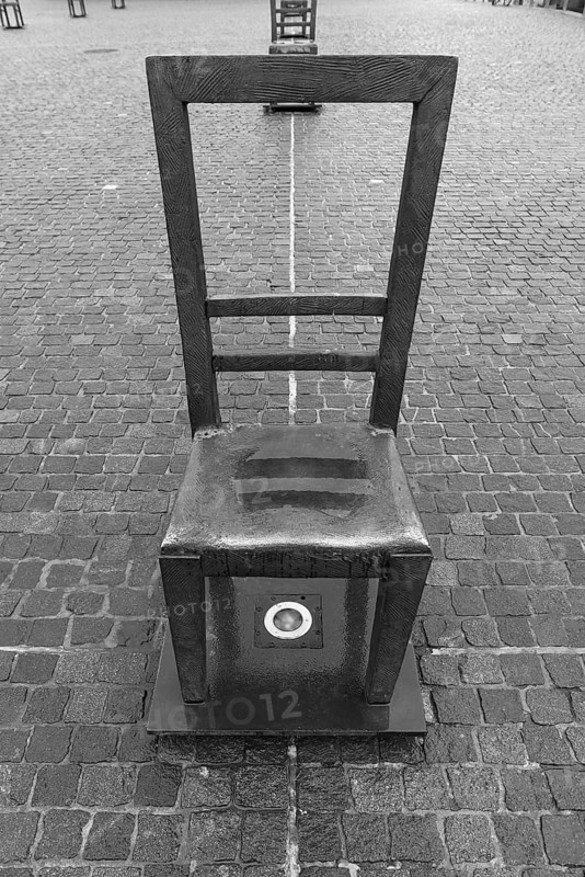 The sixty chairs memorial on the grounds of the Jewish ghetto, black and white, Krakow, Poland