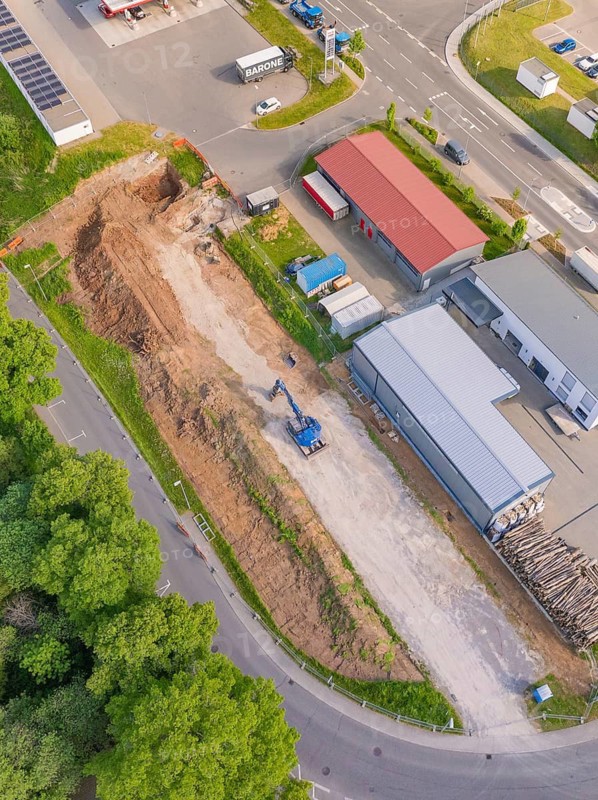 Aerial view of a construction site with excavator in an industrial park, Parkhaus Bau, Calw, Germany