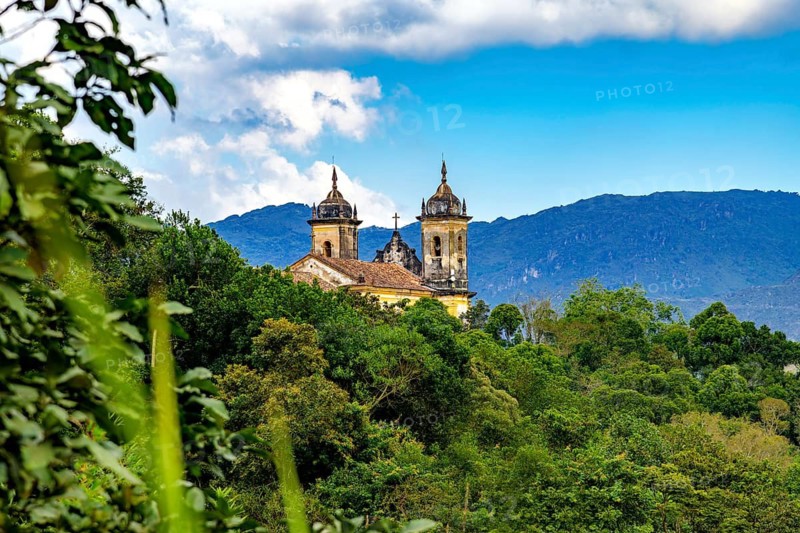 Historic Baroque church atop a hill surrounded by forest in the city of Ouro Preto, Ouro Preto, Minas Gerais, Brazil