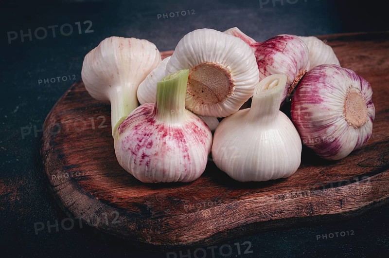 Fresh young garlic, white and purple color, on a wooden table, no people
