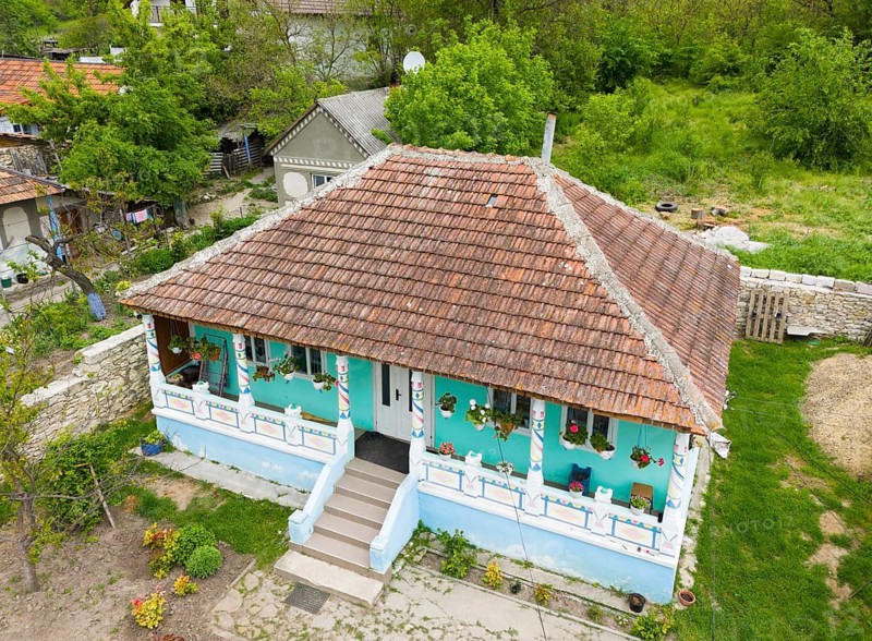 Traditional house with wooden tiles and colorful walls in a rural area with lots of greenery, aerial view, Butuceni, Old Orhei, Orheiul Vechi, archaeological site, historical-landscape reserve, Orhei district, Republic of Moldova, Moldova