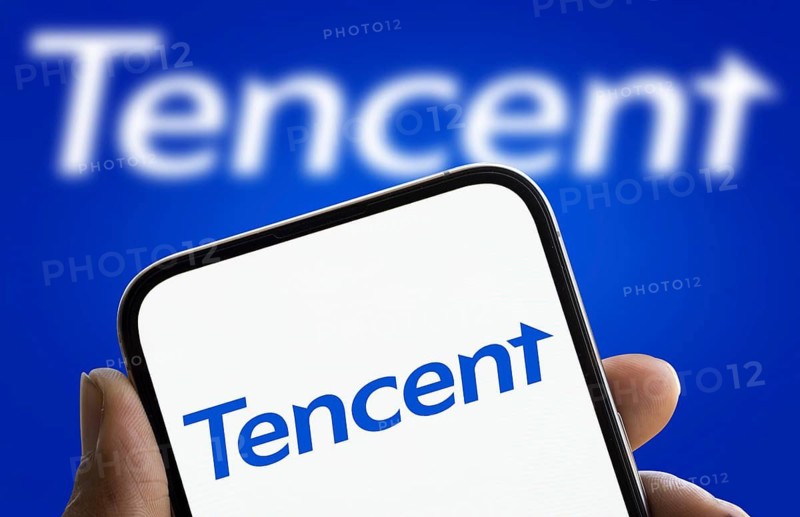 Tencent logo is displayed on smartphone. Tencent Holdings Ltd is a Chinese multinational technology conglomerate and holding company.