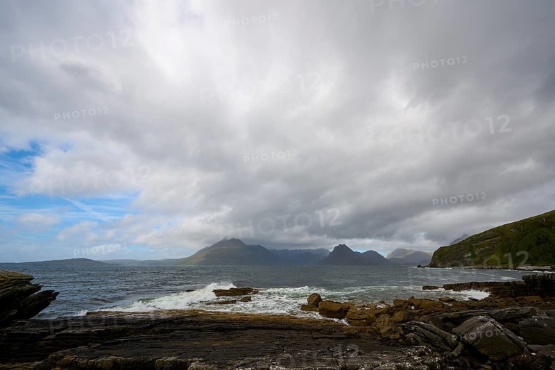 Coastal landscape with dramatic clouds over mountains and ocean rocks, Elgol Beach, Elgol, Isle of Skye, Scotland, United Kingdom, Great Britain