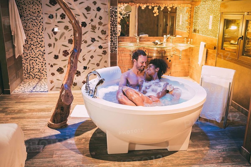 Happy young interracial couple relaxed enjoying their self in the jacuzzi