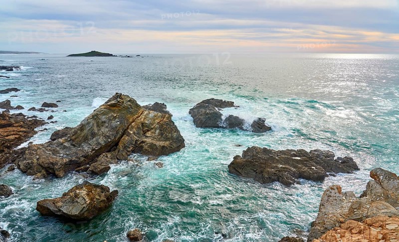 Land and seascape At the rocky and sandy coastline of the atlantic ocean in Porto Covo, Portugal