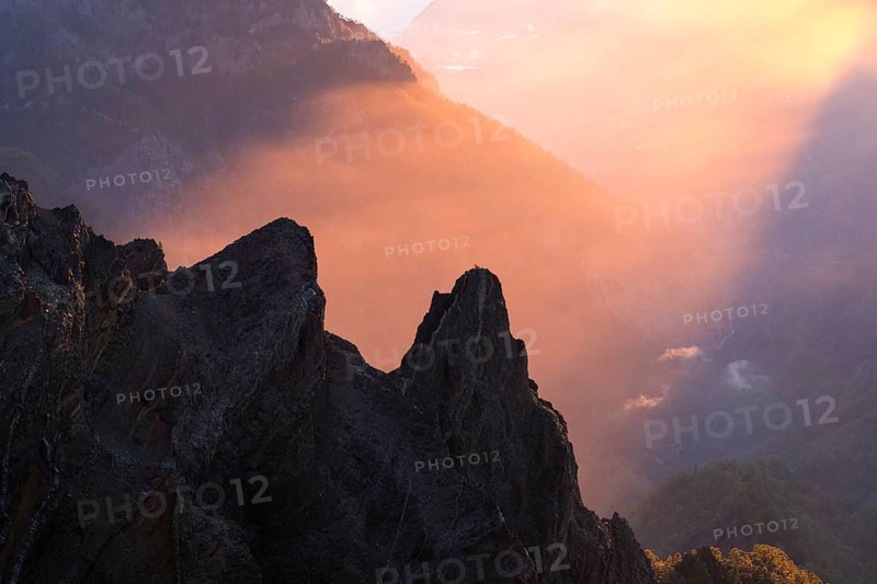 View of the Caldera de Taburiente from Pico de La Nieve at sunset and back light. In the back left, Mount Bejenado. La Palma, Canary Islands, Spain