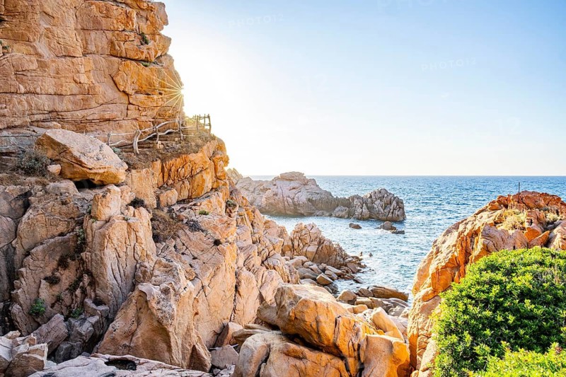 Landscape of the coastline with blue water at Costa Paradiso on a sunny day at evening, Sardinia, Italy