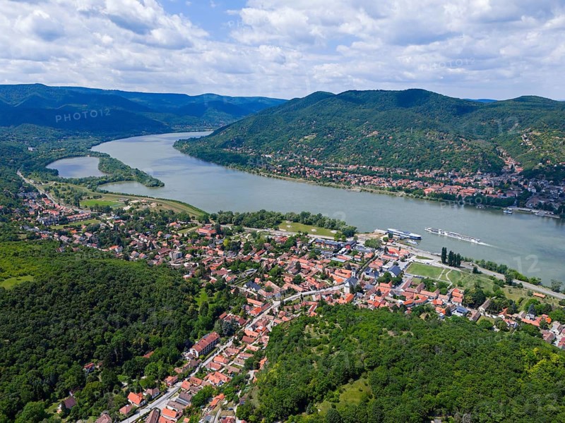 Wide river valley with red tiled roofs, green forests and surrounding mountains, aerial view, Danube bend, Visegrád, Visegrad, Plintenburg, Szentendre district, Pest county, Central Hungary region, Hungary