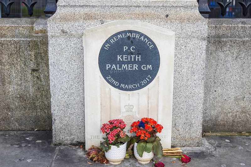 A stone memorial with floral tributes honours PC Keith Palmer, killed outside the Houses of Parliament on 22 March 2017, London, England, United Kingdom