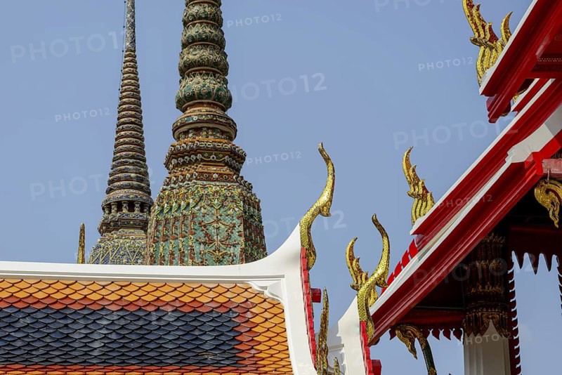 Golden mosaic ornaments rise like flames to heaven carried by Chofa and Bai Raka on the ornate pediment of the Wat Pho Temple, a brilliant detail of Thai religious architecture, Wat Pho, Bangkok, Thailand