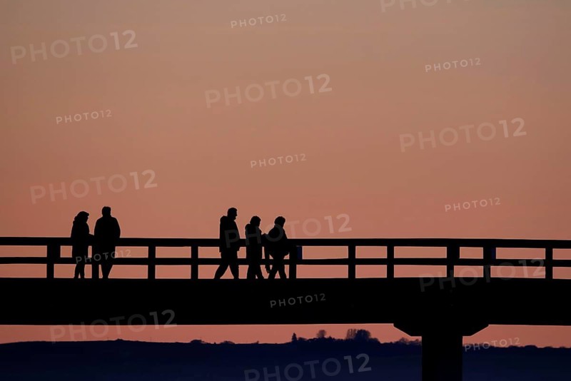 Holidaymakers at sunset on the Sellin pier, Mecklenburg-Western Pomerania, Germany