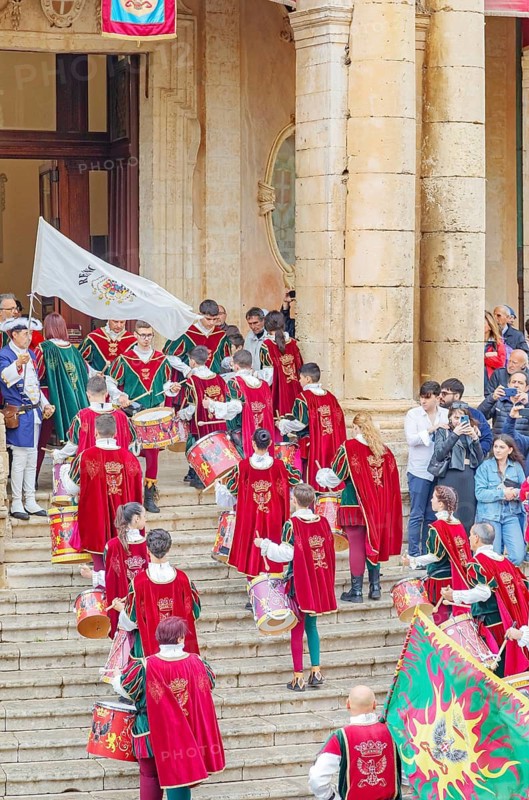 Participants wearing historical costumes entering city hall, Noto, Noto Valley, Sicily, Italy