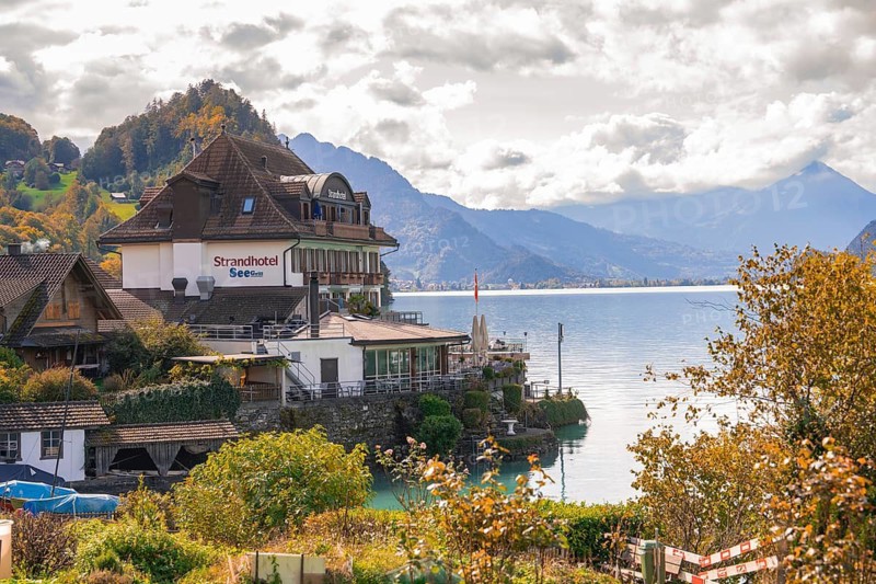 Inviting hotel on the lakeshore with magnificent mountain panorama, Lake Brienz, Switzerland