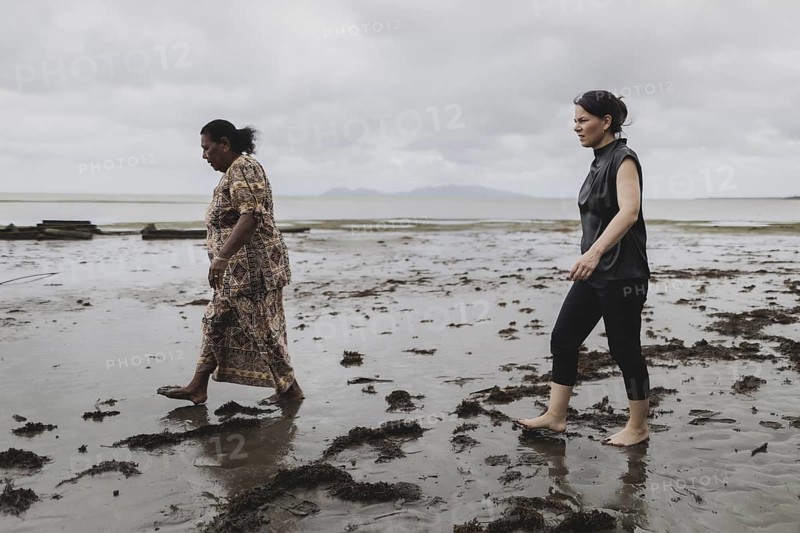 (R-L) Annalena Bärbock (Bündnis 90/Die Grünen), Federal Foreign Minister, and Lavenia McGoon, resident of the Togoru settlement, photographed during a briefing on coastal erosion at a cemetery near the Togoru settlement flooded by rising sea levels, 07.05.2024. Bärbock is travelling to Australia, New Zealand and Fiji for political talks / Photographed on behalf of the Federal Foreign Office