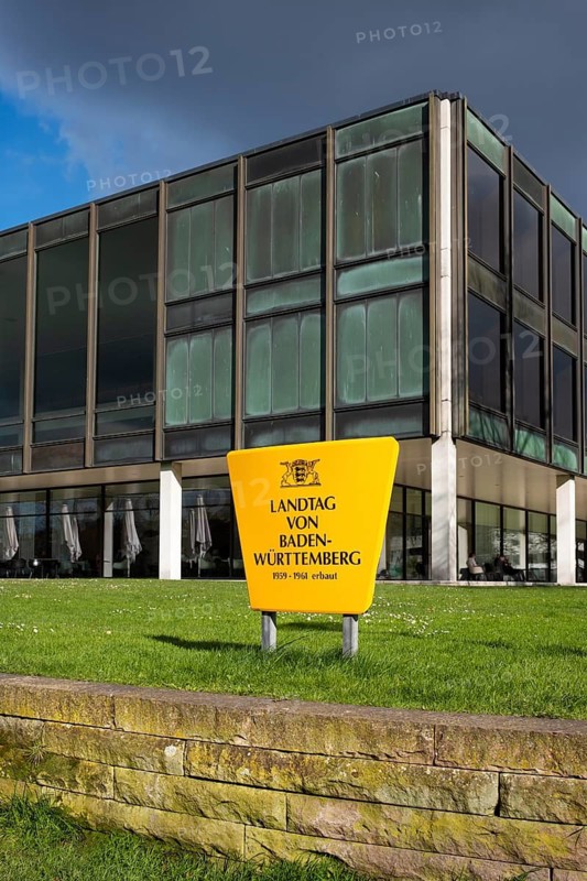 Information sign with the inscription State Parliament of Baden-Württemberg and the state coat of arms, behind it the glass building of the state government built between 1959 and 1961, Stuttgart, Baden-Württemberg, Germany