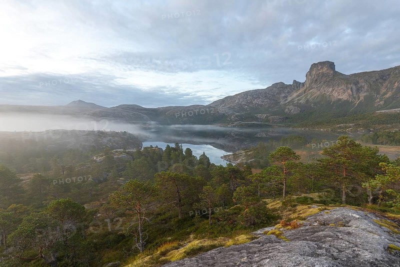 Magical morning fog on Steigtindvatnet in front of the majestic Steigtinden in Norway near Bodø