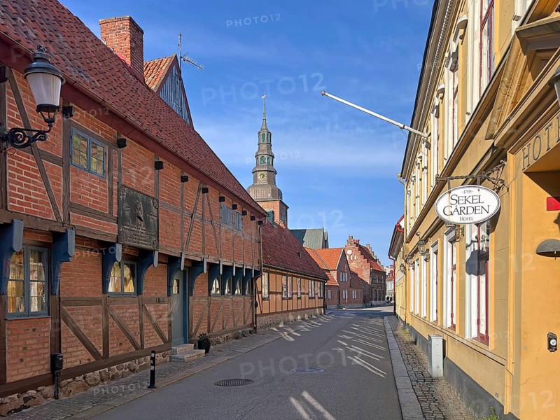 A historic old town with half-timbered houses and a church under a blue sky, Wallander, crime series, Skane, Ystad, Sweden