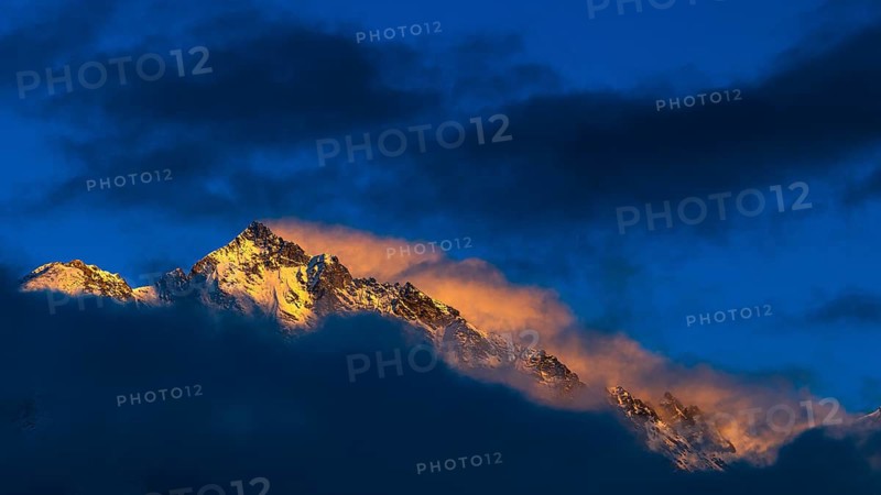 Snow-covered summit of the Weisshorn mountain, illuminated by the evening sun, view from Grimentz, Val d'Anniviers, Valais Alps, Canton Valais, Switzerland